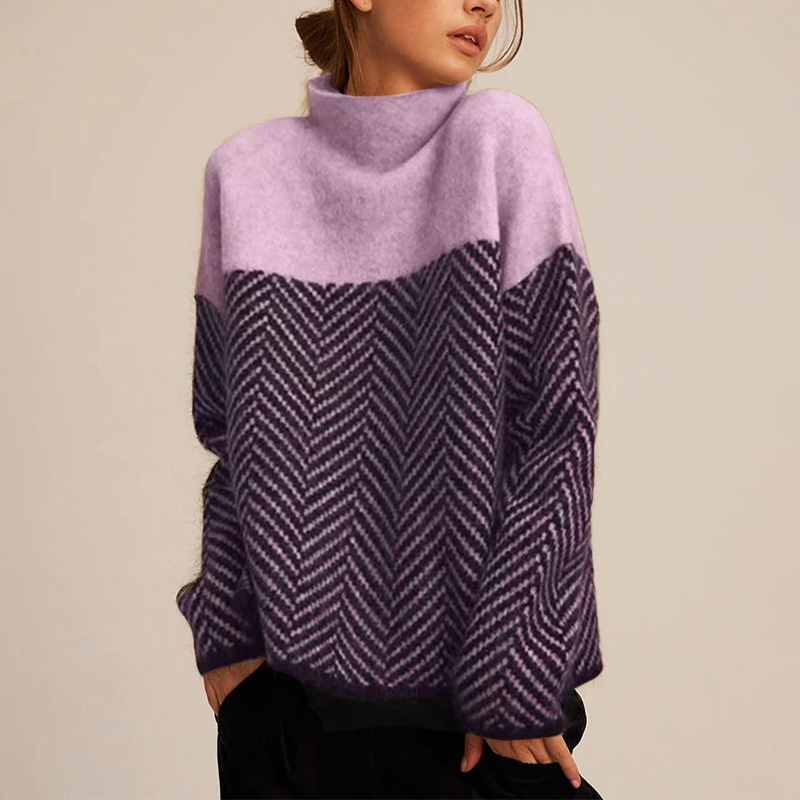 Woman wearing a lavender and charcoal color-block knit sweater with a mock neck, textured herringbone pattern, and long sleeves.