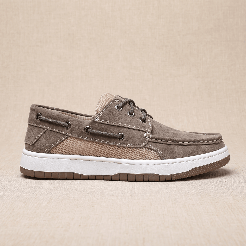 Side profile view of a single gray suede Adrian boat shoe showing the tan mesh panel and layered rubber sole