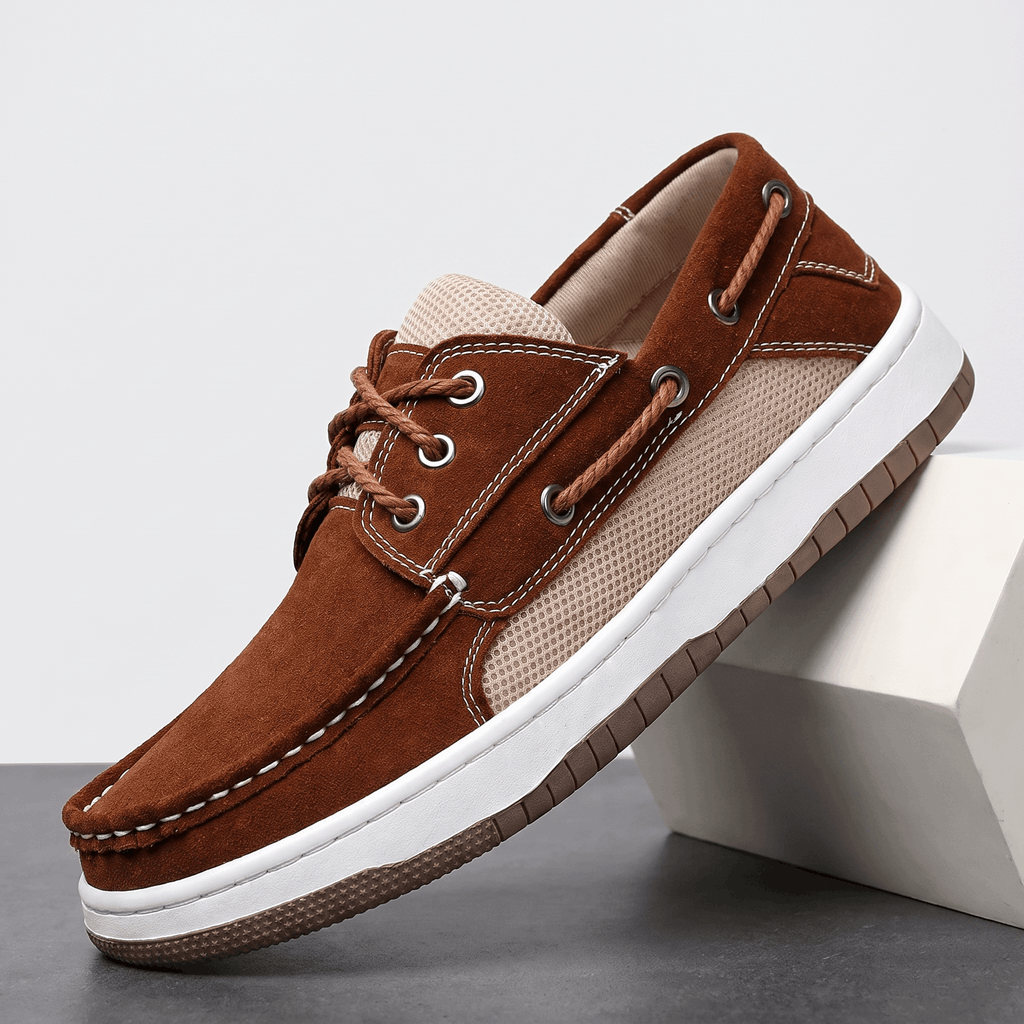 Single dark brown suede Adrian boat shoe with beige mesh panel and white sole, tilted against a white block