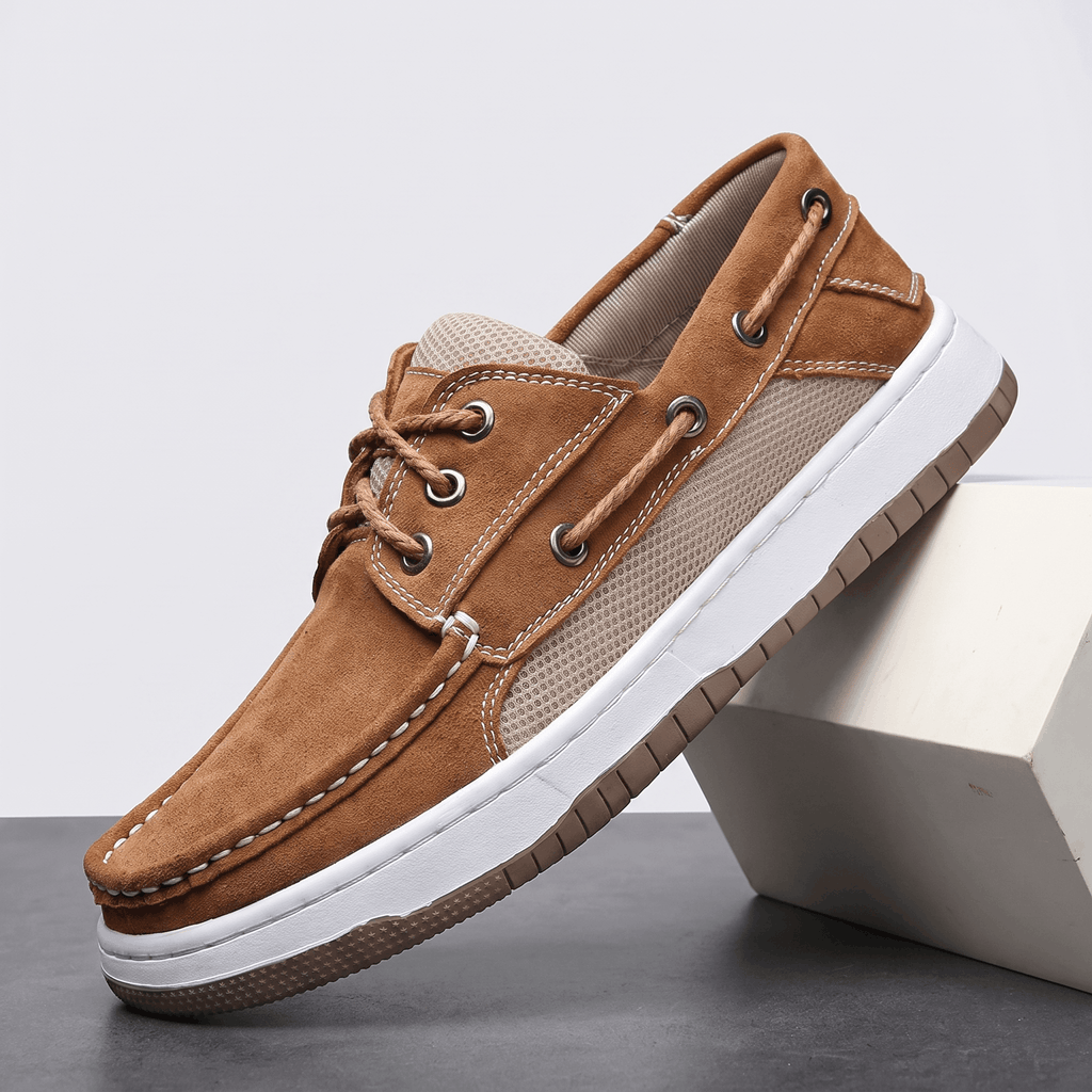 Single tan suede Adrian boat shoe with beige mesh side panel and rope laces, tilted against a white block on a gray surface