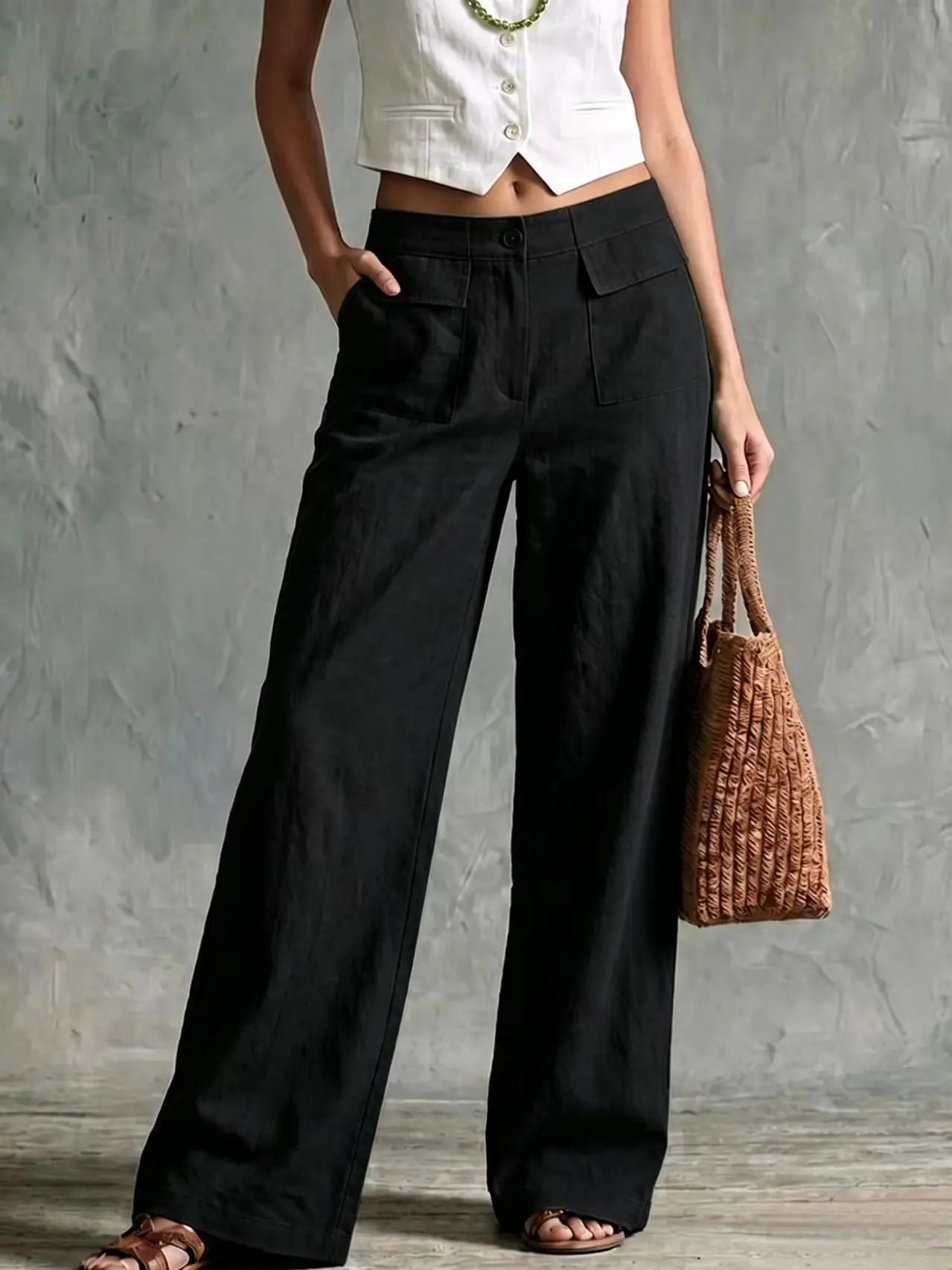 Women's black high-waisted wide-leg linen pants with front pleats and a loose, comfortable fit.