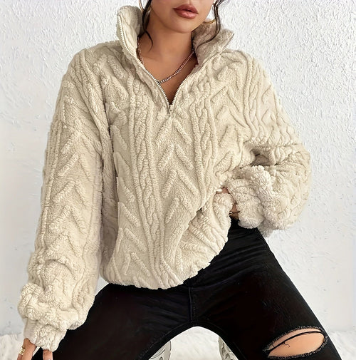 Cream-colored cropped sherpa half-zip sweater with sculpted chevron texture, stand collar, and banded hem.