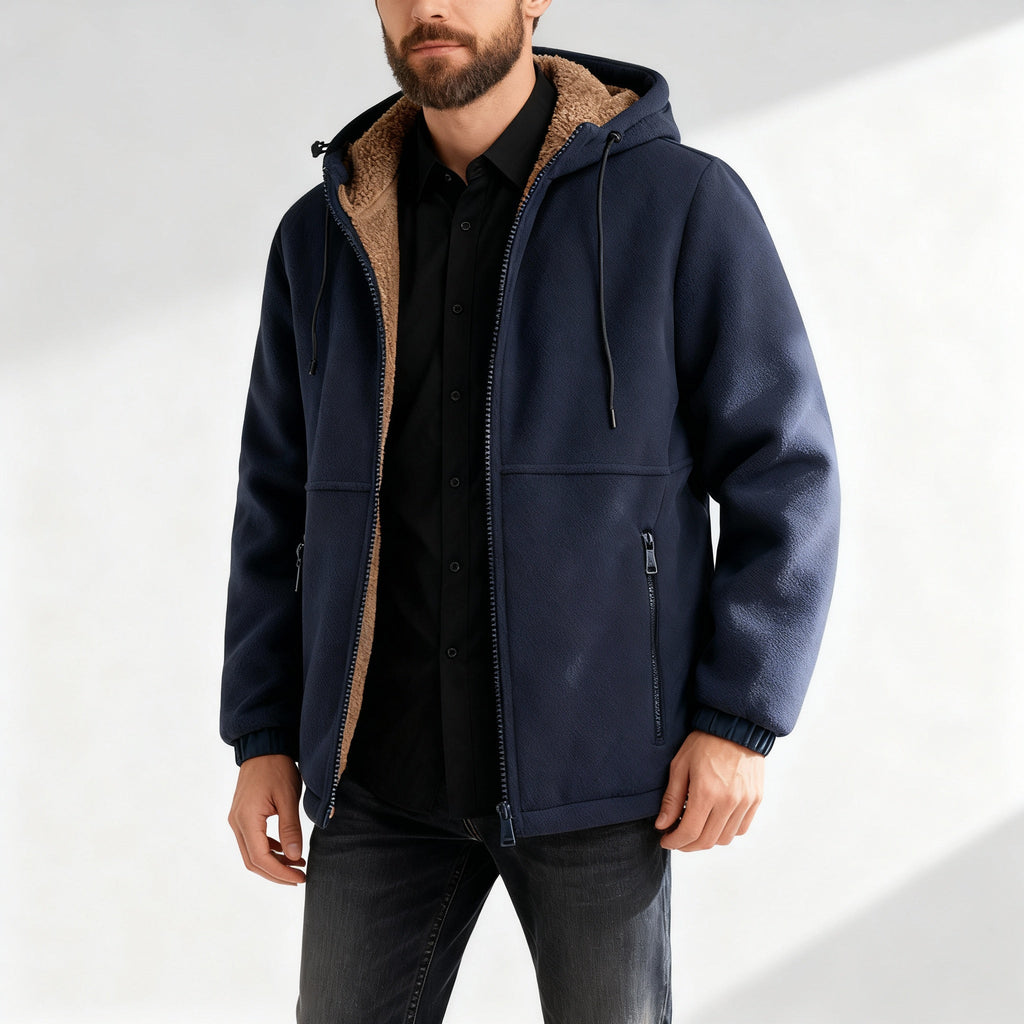 Man wearing a navy blue jacket with a sherpa-lined collar, front zip closure, and relaxed fit.