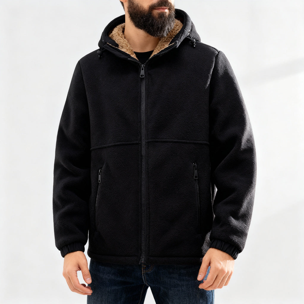 Man wearing a black jacket with a sherpa-lined collar, front zip closure, and relaxed fit.