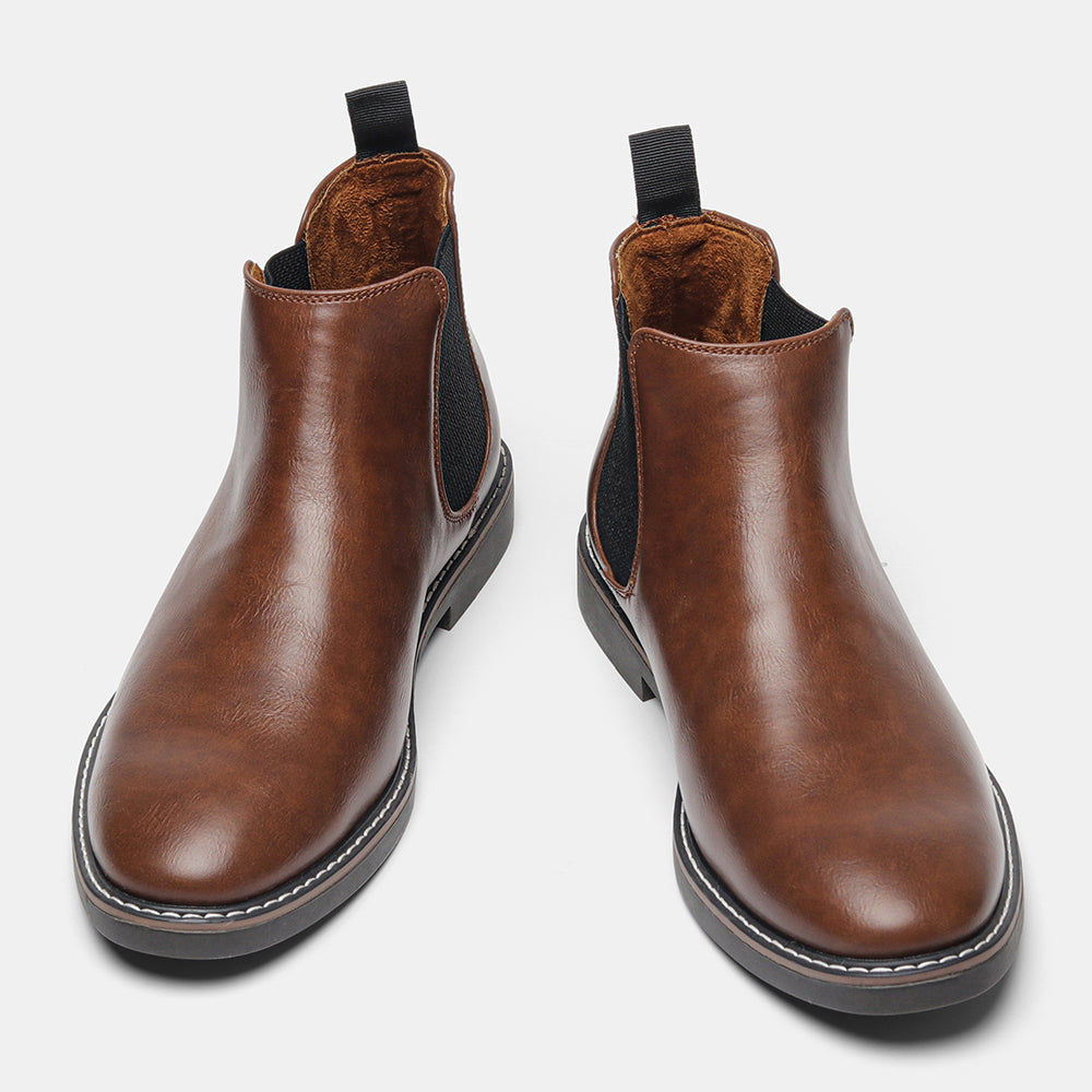 Pair of brown leather Chelsea boots standing upright, showing the soft brown interior lining, on a plain white background.