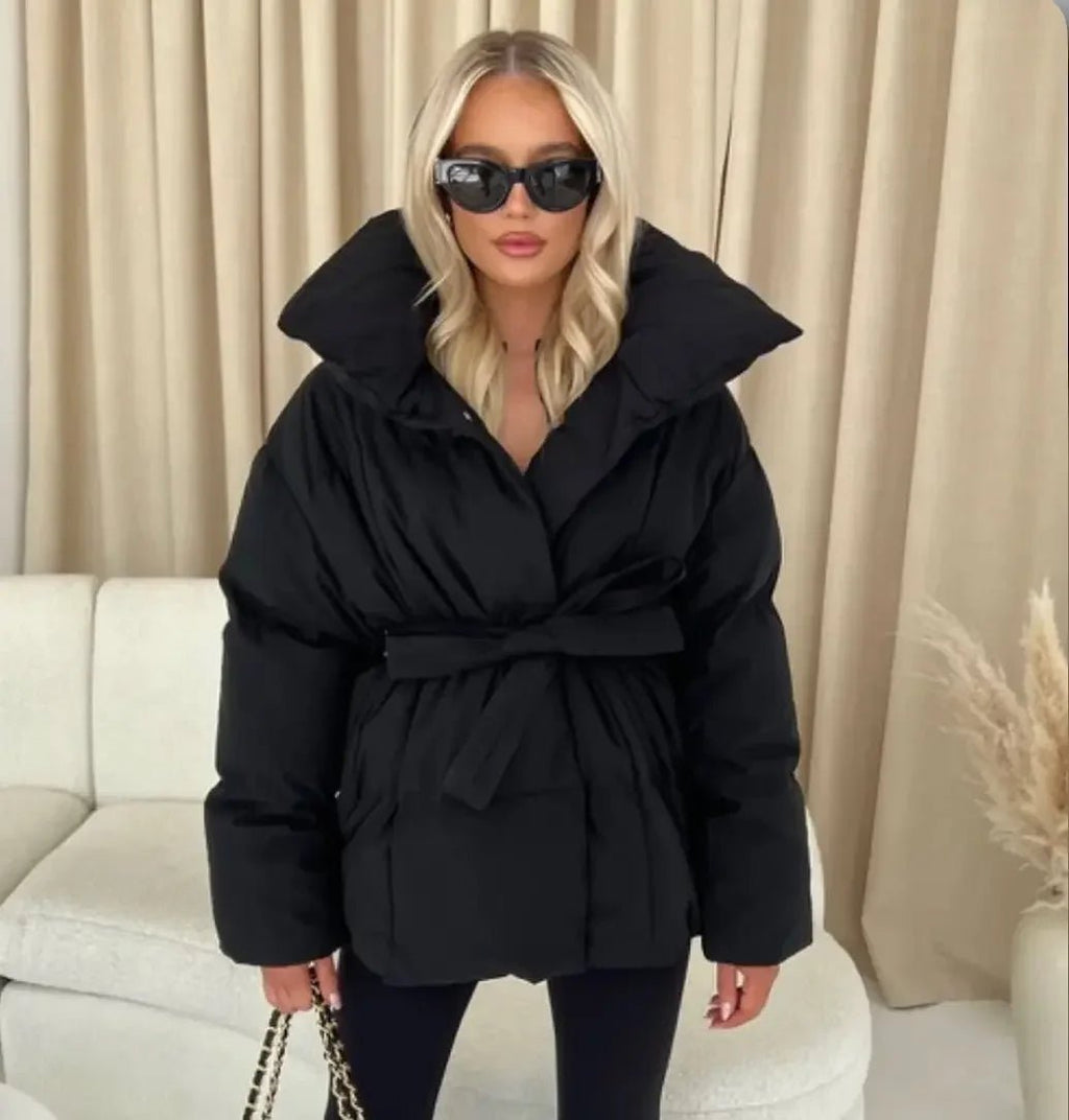 Black oversized puffer jacket in quilted shell with a high stand collar and self-tie waist belt.