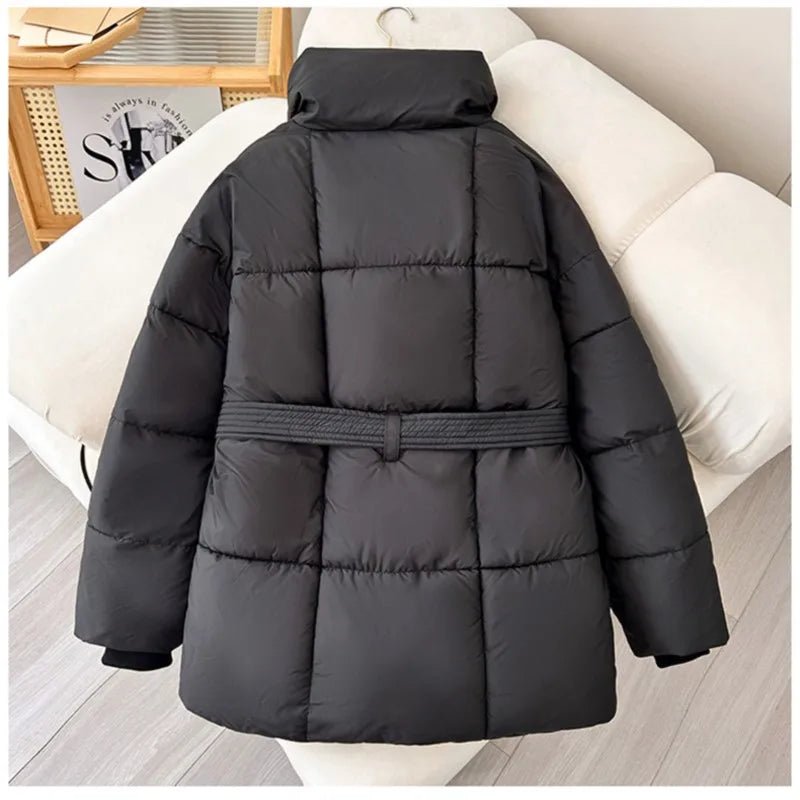 Black quilted puffer jacket with an oversized fit, high stand collar, and a matching self-tie waist belt.