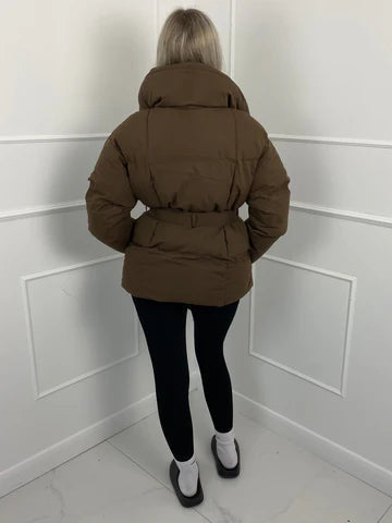 Brown oversized puffer jacket in quilted shell fabric with a high stand collar and matching waist-cinching belt.