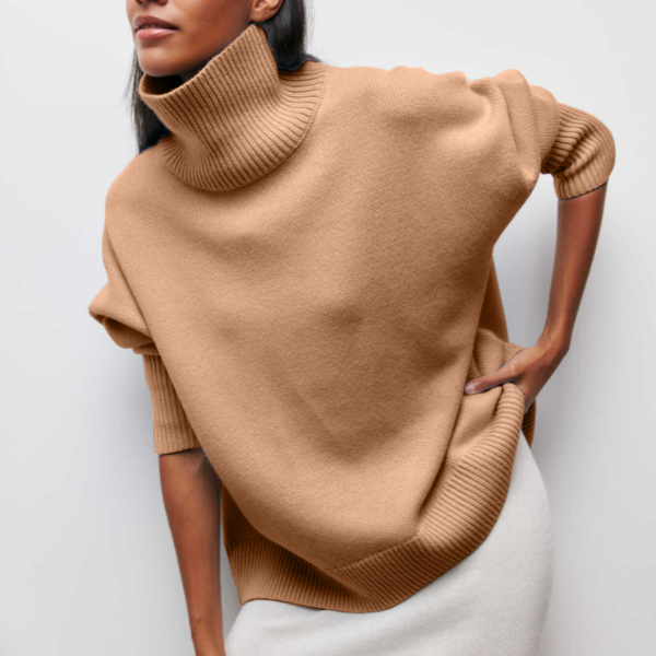 Woman wearing a camel oversized ribbed turtleneck sweater featuring short sleeves and a loose, comfortable fit.