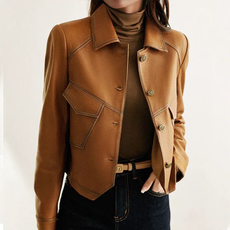 Close-up front view of brown leather jacket highlighting the structured collar and topstitched panels