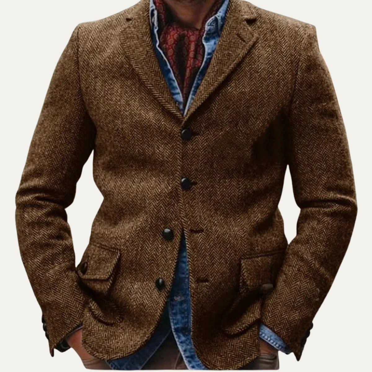 Men's brown tweed blazer featuring a notched lapel, two-button closure, flap pockets, and a tailored fit layered over a denim shirt and knit sweater.