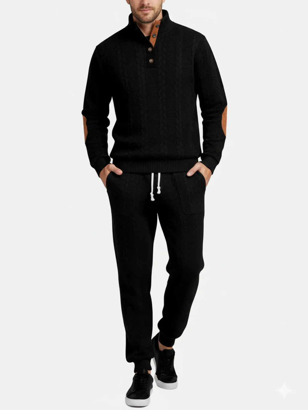 Man wearing a black quarter-zip sweatshirt with matching jogger pants and athletic sneakers.