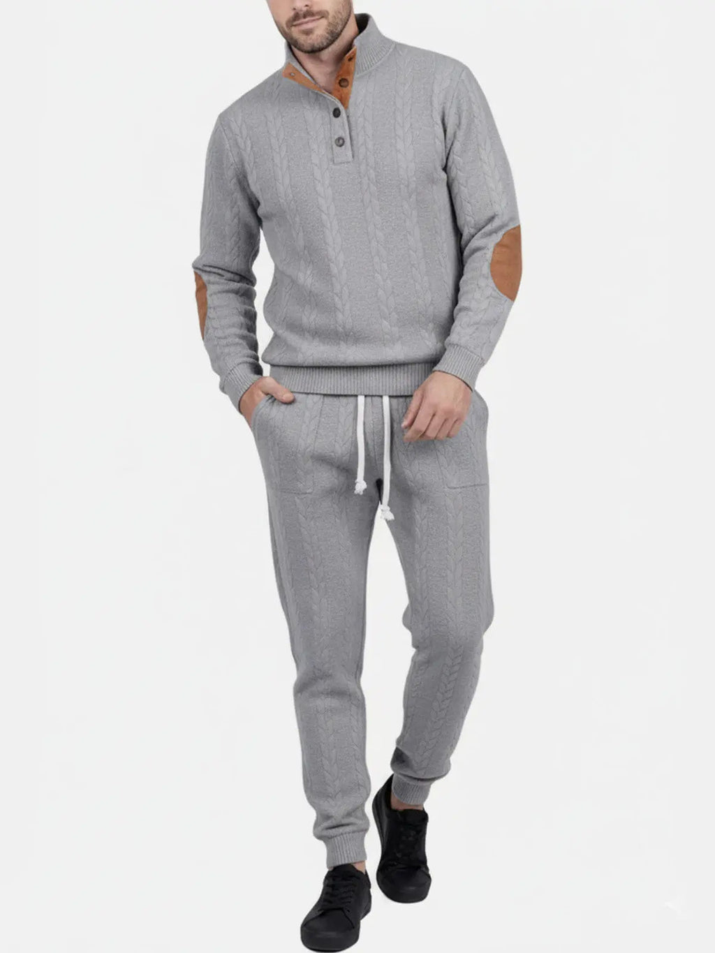 Man wearing a light gray quarter-zip sweatshirt with matching jogger pants and a comfortable relaxed fit.