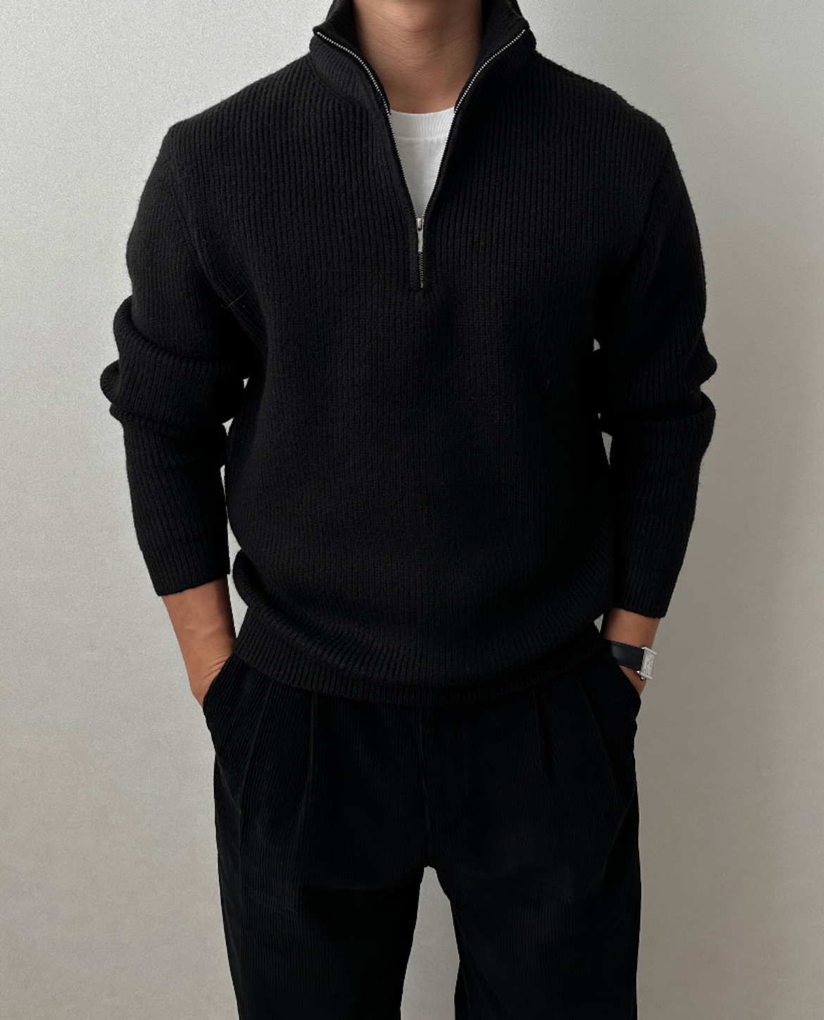 Black brushed rib-knit quarter-zip sweater with a stand collar, worn over a white tee in a regular fit.