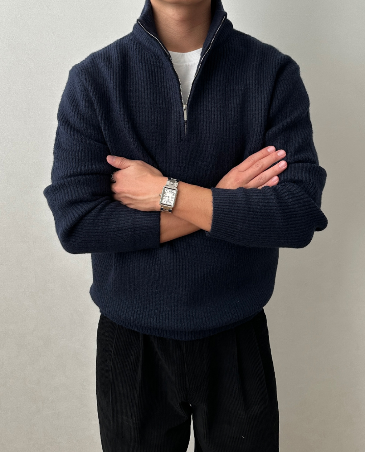 Navy blue brushed rib-knit quarter-zip sweater with a stand collar and regular fit, worn over a white tee.