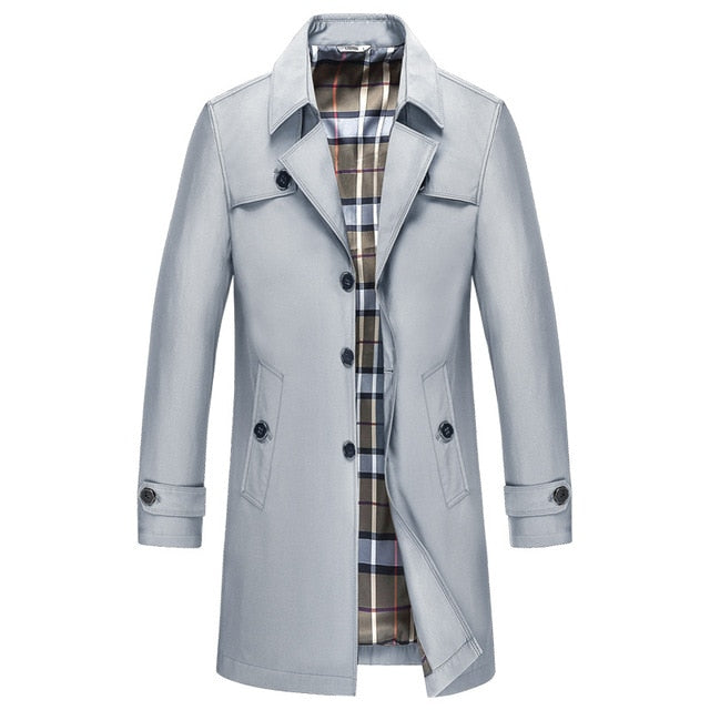 Light gray double-breasted mid-length trench coat with a structured lapel, button closure, and checked interior lining.