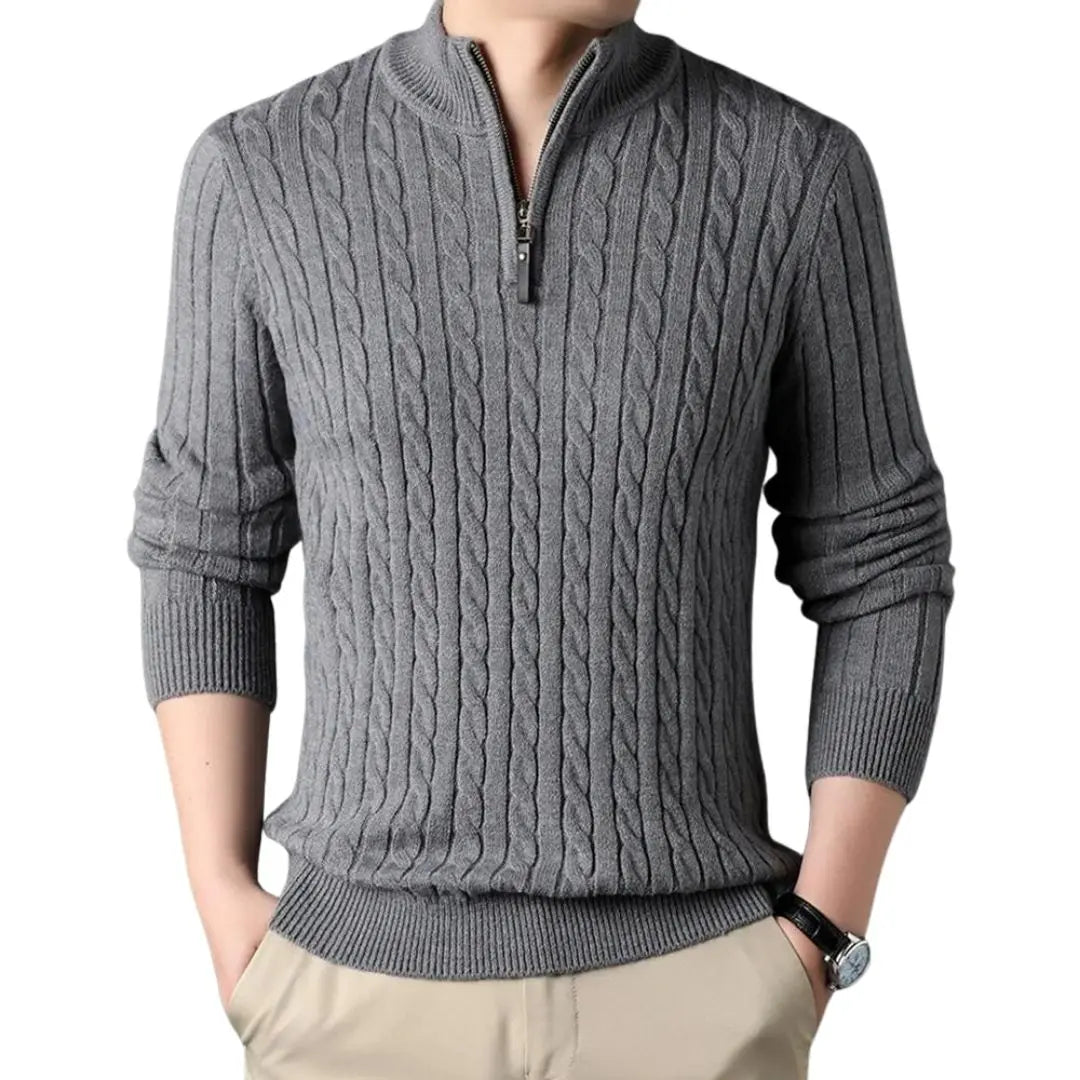 Gray cable knit quarter-zip sweater with a ribbed mock neck and tailored fit, worn with beige chinos.