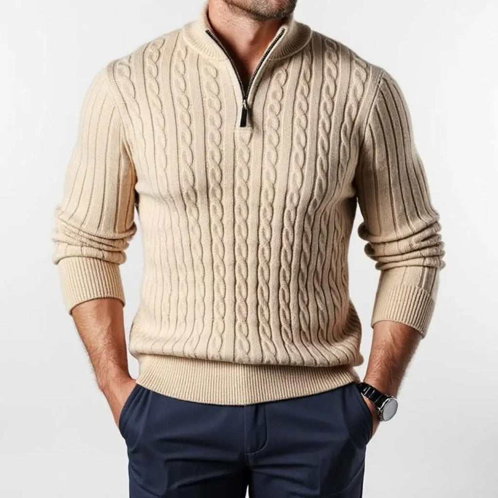 Beige cable knit quarter-zip sweater with a ribbed mock neck and tailored fit, worn with navy chinos.