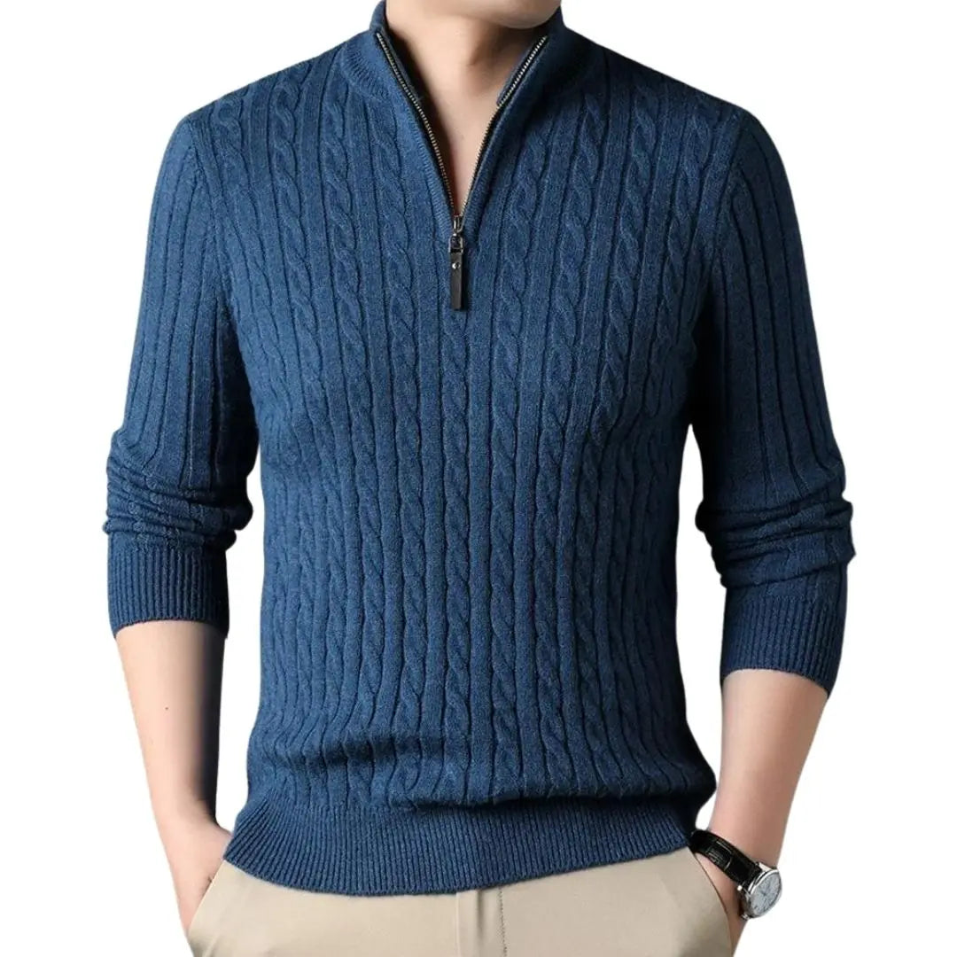 Blue cable knit quarter-zip sweater with a ribbed mock neck and tailored fit, worn with neutral chinos.