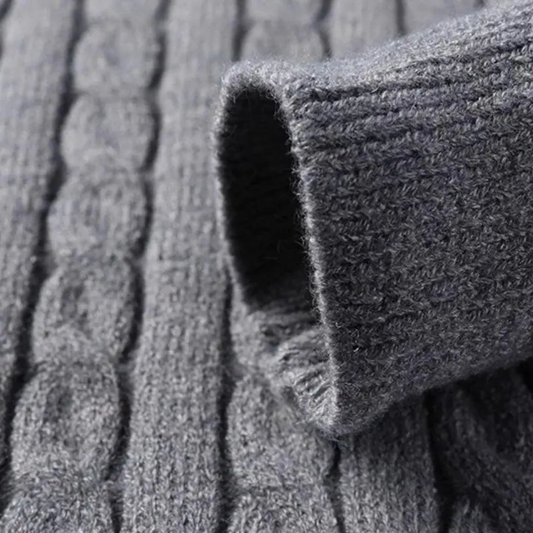 Charcoal grey cable knit sweater featuring a narrow cable texture and a durable, close-knit ribbed cuff.