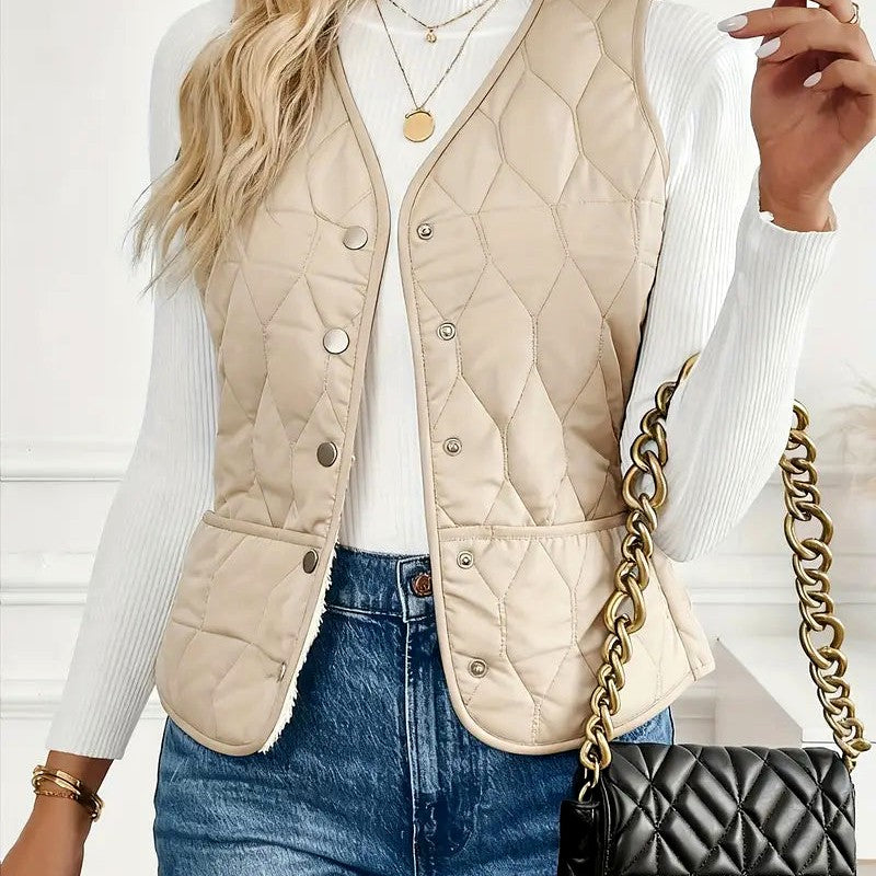 Front view of a women's off-white quilted puffer vest featuring diamond quilting, a stand collar, and snap-button closure.