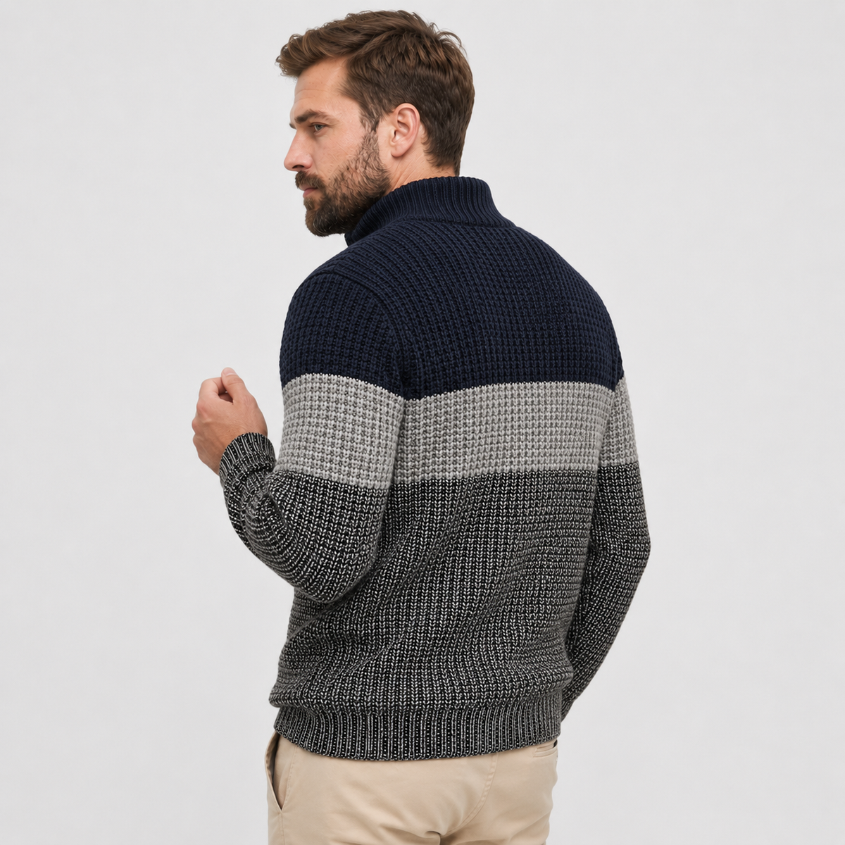 Chunky knit quarter-zip sweater in navy, grey, and charcoal colorblock stripes with a ribbed stand collar and hem.