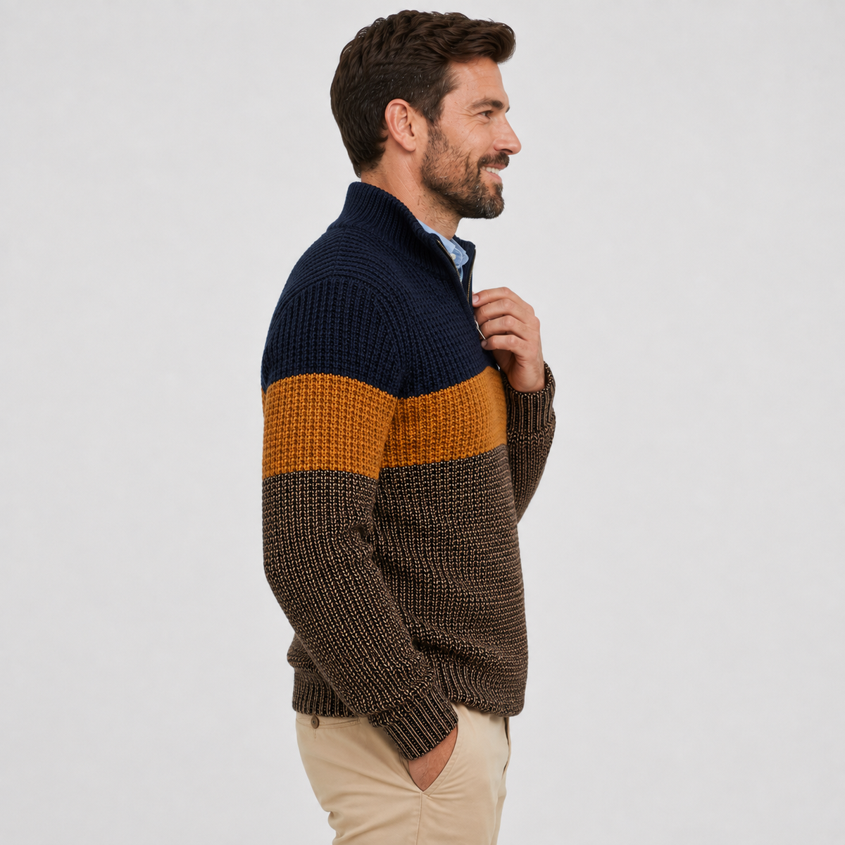Chunky knit quarter-zip sweater in navy, ochre, and brown colorblock stripes with a stand collar and ribbed trim.