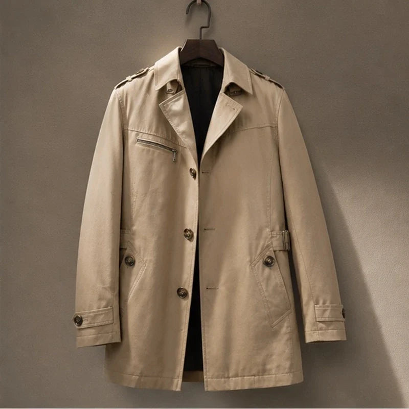 Beige cotton-blend trench coat featuring a button-front closure, shoulder epaulettes, and a functional zip chest pocket.