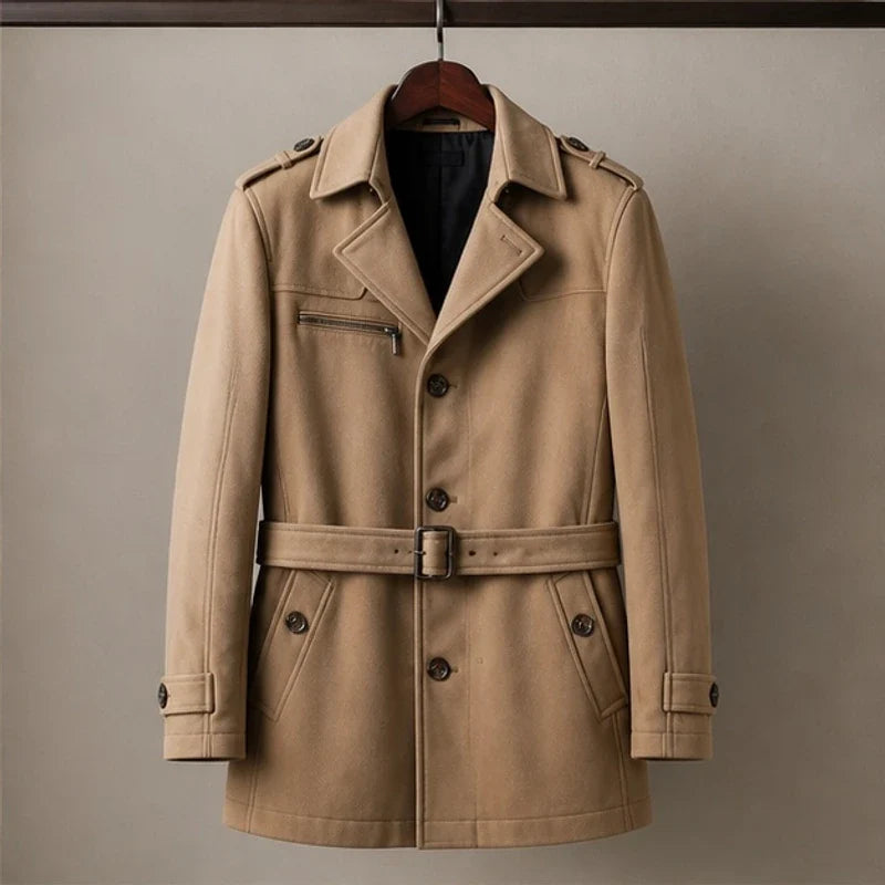 Tan cotton-blend trench coat with a belted waist, notched lapels, shoulder epaulettes, and a zip chest pocket.