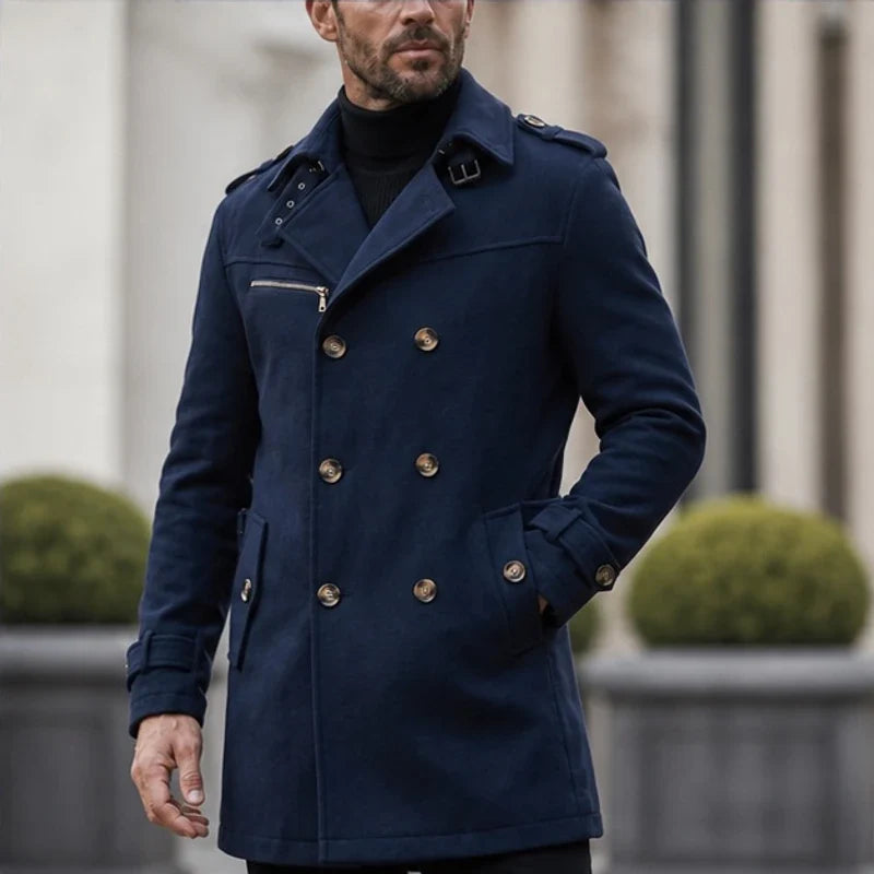 Navy blue cotton-blend trench coat with double-breasted button front, shoulder epaulettes, and zip chest pocket.