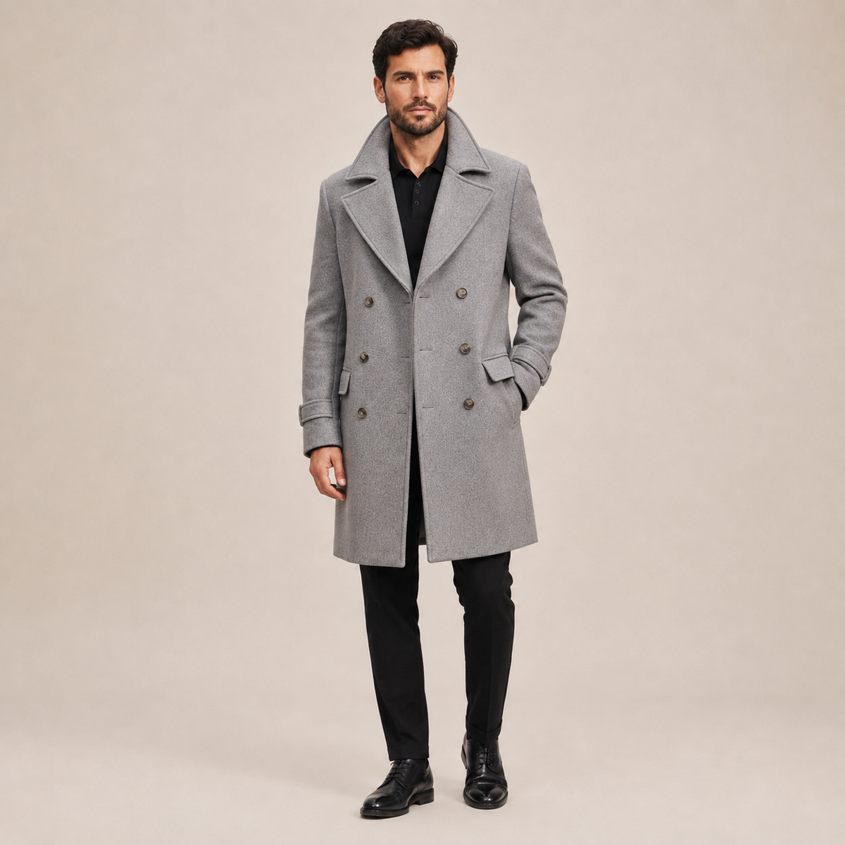 Gray wool-blend double-breasted overcoat with wide notched lapels and structured shoulders worn over a black polo.