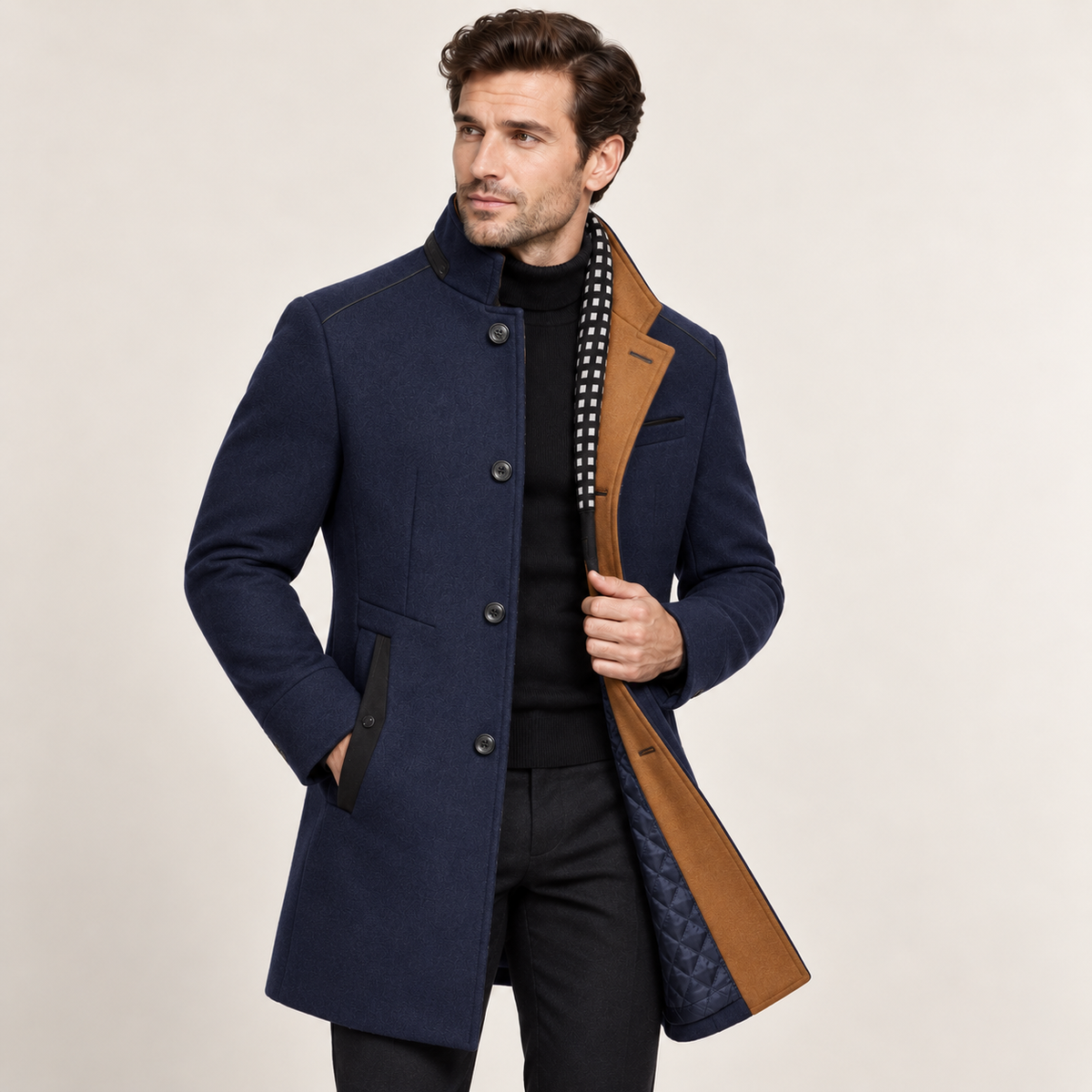 Navy wool overcoat with a raised collar, tan colorblock lapel, and single-breasted button front on a model.