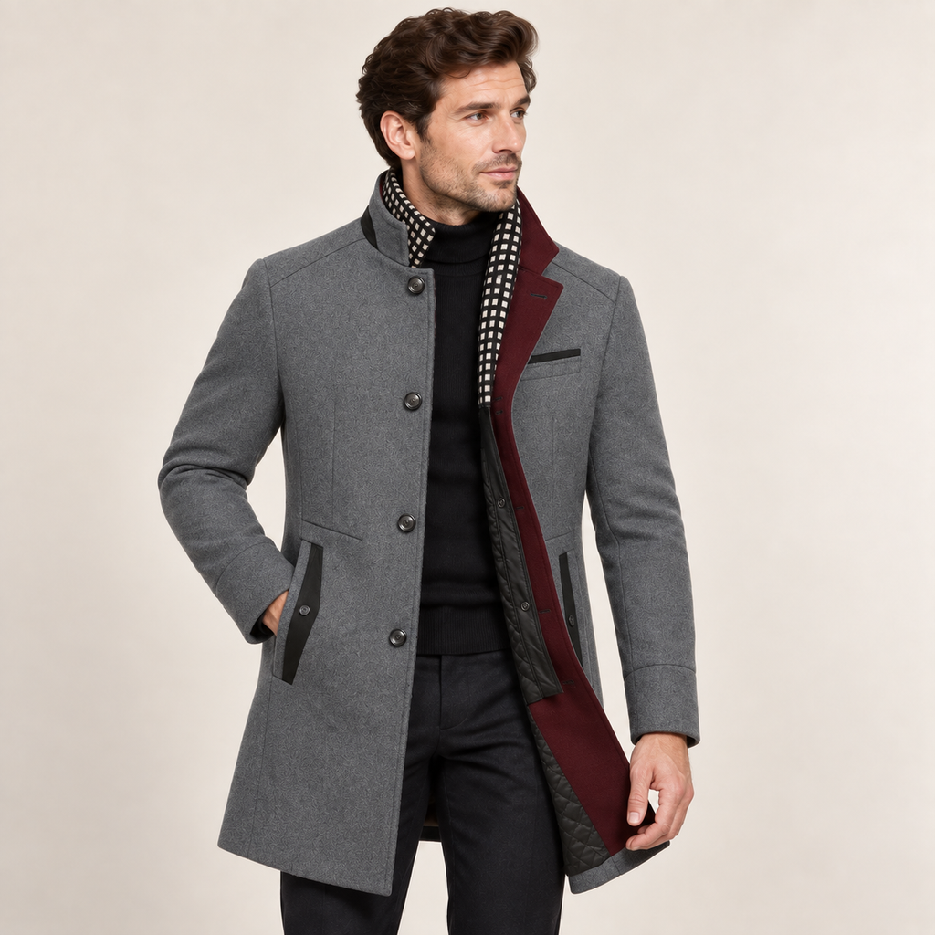 Grey wool overcoat with a raised collar, single-breasted button front, and contrasting burgundy colorblock lining.