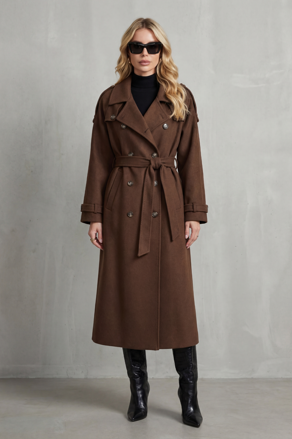 Oversized brown wool trench coat with a double-breasted front, notched lapels, and a belted waist.