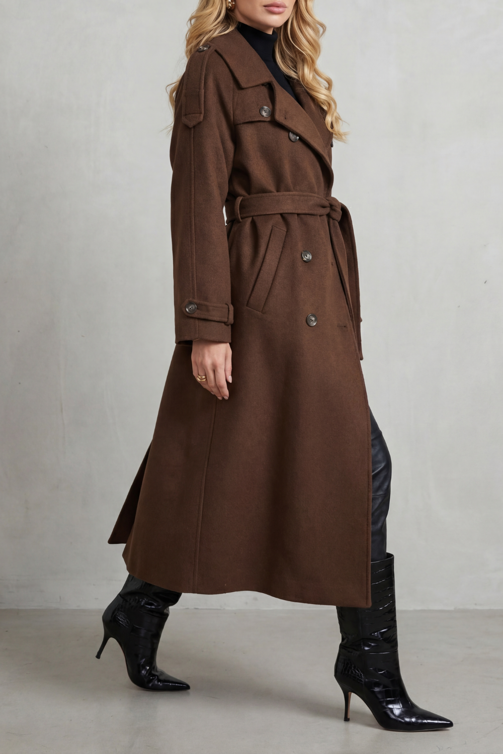 Oversized brown wool trench coat with a double-breasted front, notched lapels, and a belted waist.