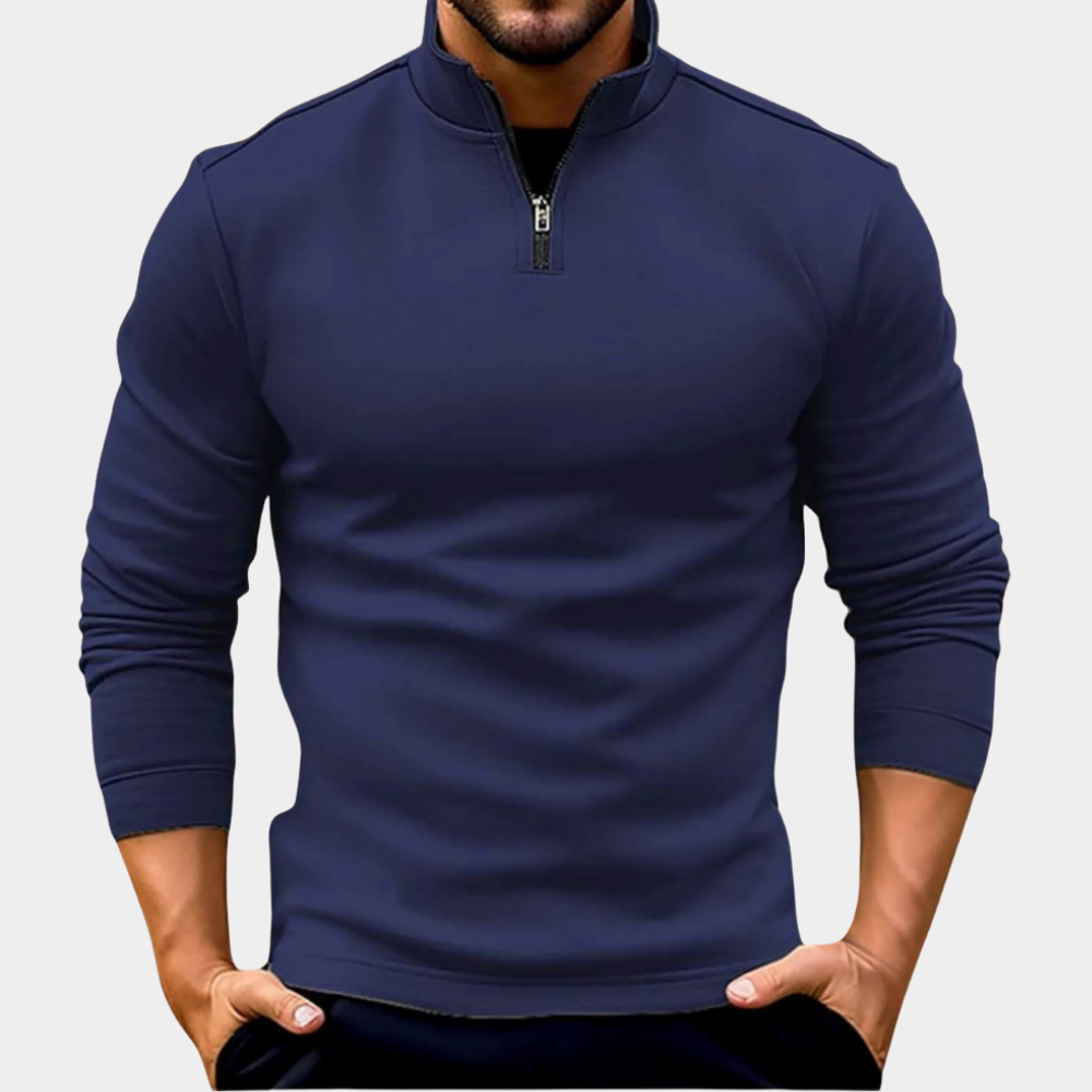 Navy half-zip fleece sweatshirt featuring a stand collar and long sleeves, paired with dark jeans on a white background.