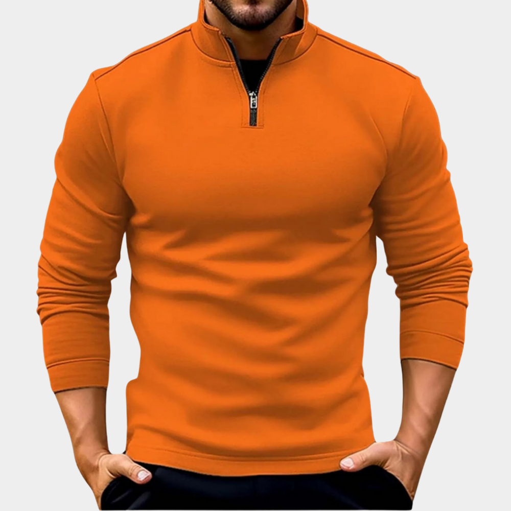 Orange half-zip fleece sweatshirt with a stand collar and long sleeves, styled with dark jeans on a white background.