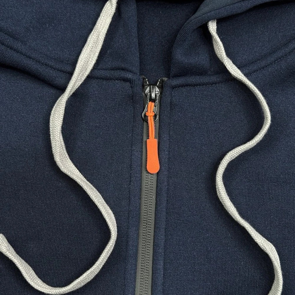 Close-up of the tactical hoodie half-zip closure with adjustable drawstrings and contrast orange zipper pull.