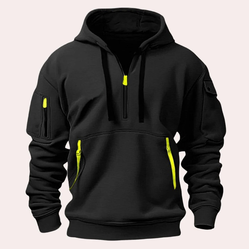 Black tactical pullover hoodie with a half-zip neckline, adjustable hood, kangaroo pocket, and utility sleeve zip pocket displayed on a white background.