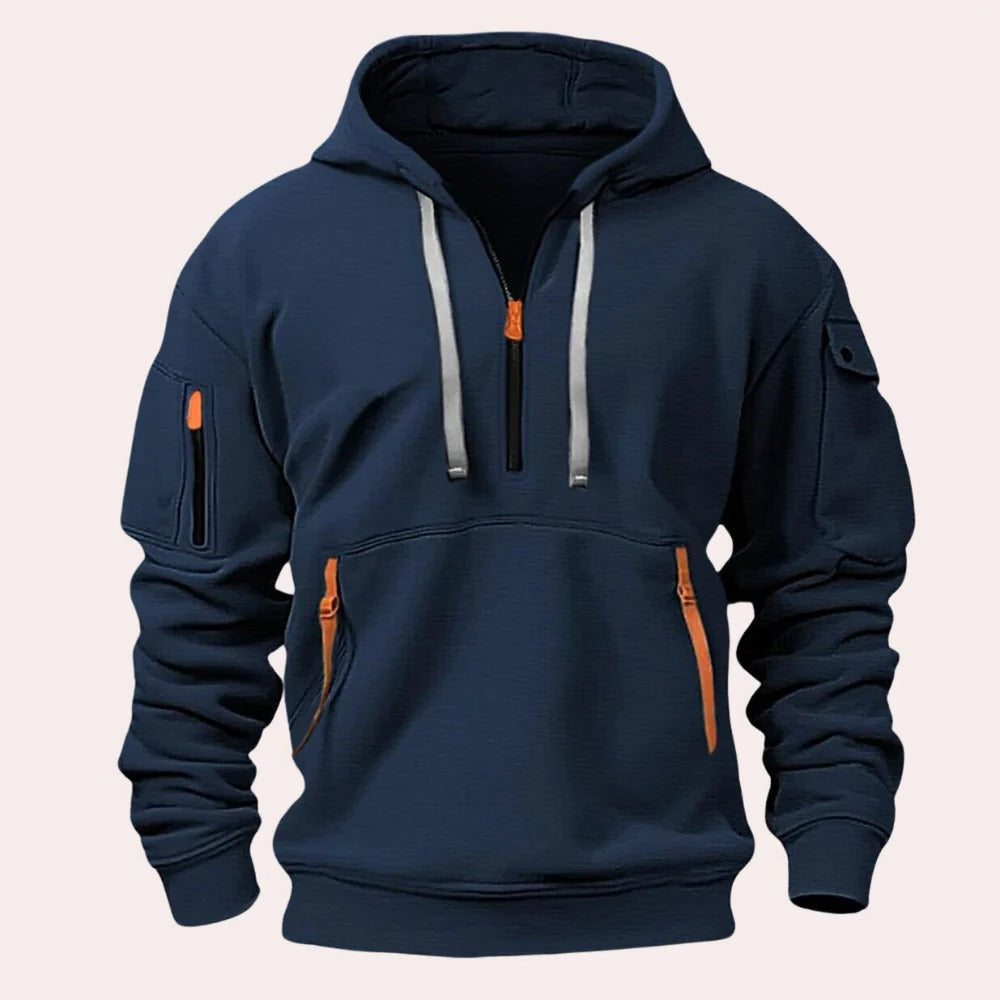 Navy tactical pullover hoodie with a half-zip neckline, adjustable hood, kangaroo pocket, and utility sleeve zip pocket displayed on a white background.