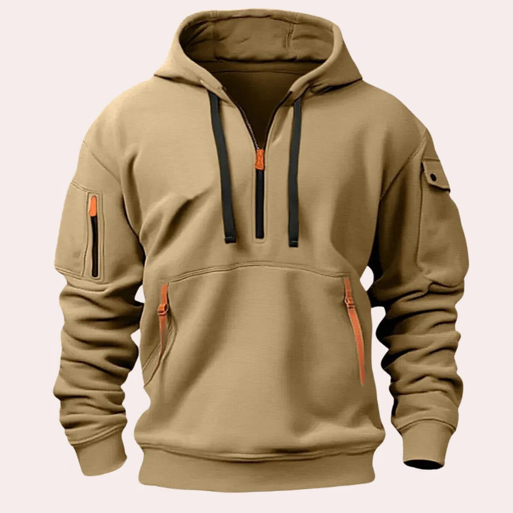 Khaki tactical pullover hoodie with an adjustable hood, half-zip neckline, sleeve zip pocket, kangaroo pocket, and contrast zipper accents displayed on a white background.