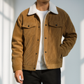 Man wearing a tan corduroy jacket with a white sherpa collar, button-front closure, flap chest pockets, long sleeves, and a relaxed fit.