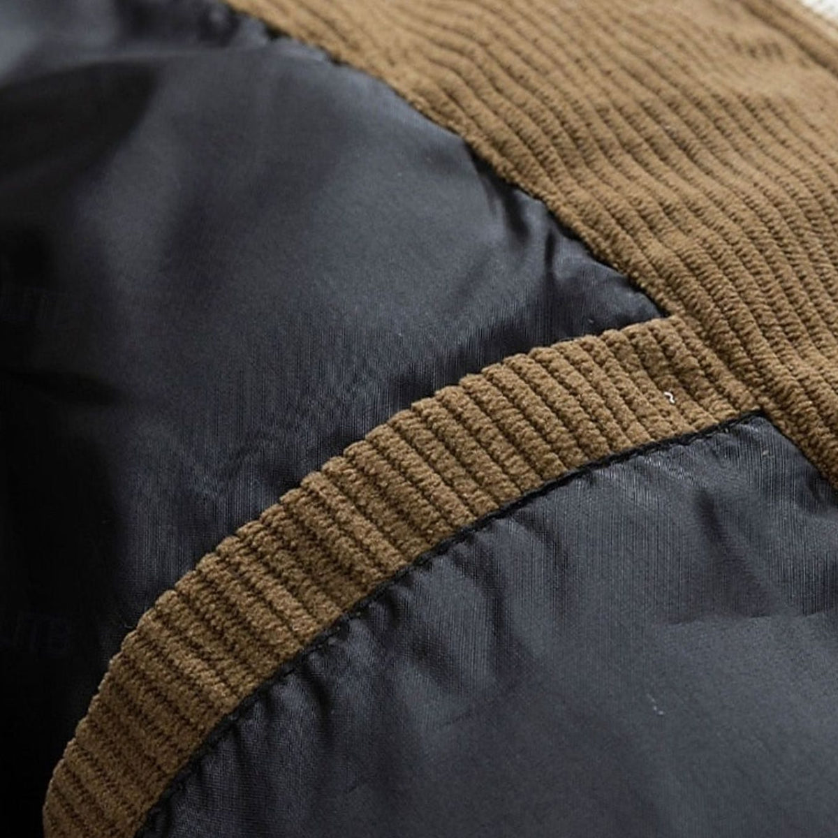 Close-up of a puffer jacket showing the corduroy trim and quilted padding detail