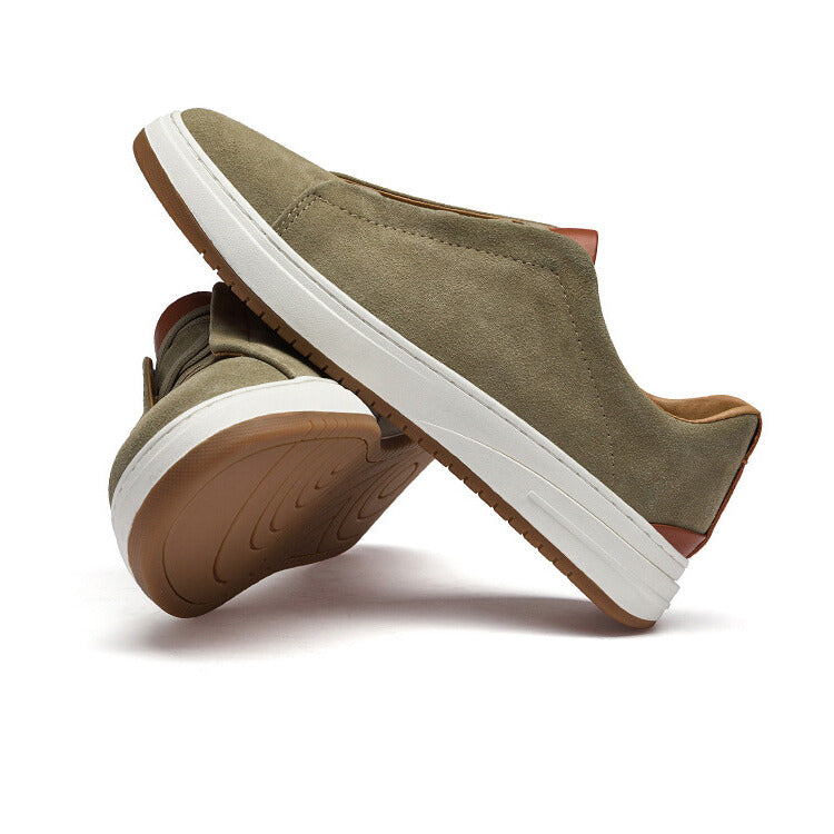 Pair of olive suede Dominic slip-on sneakers stacked at an angle showing the tan tread sole, on a plain white background
