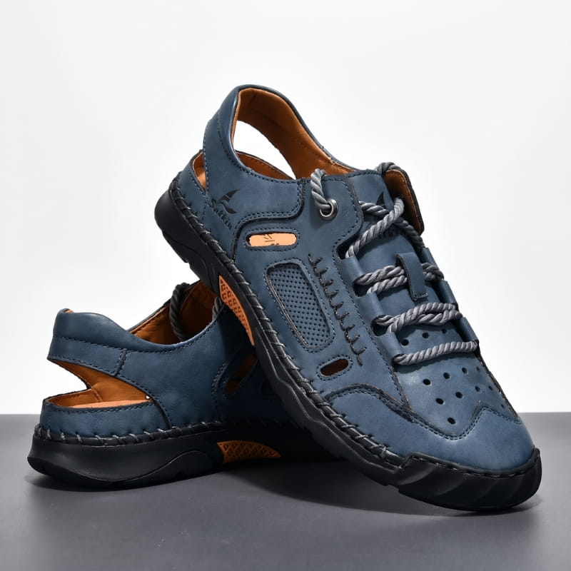 Pair of blue nubuck leather fisherman sandals stacked on a white studio backdrop