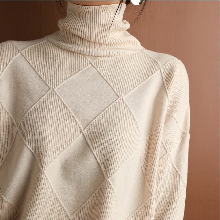 Back view of a cream ribbed turtleneck sweater showcasing the textured knit design and relaxed fit.