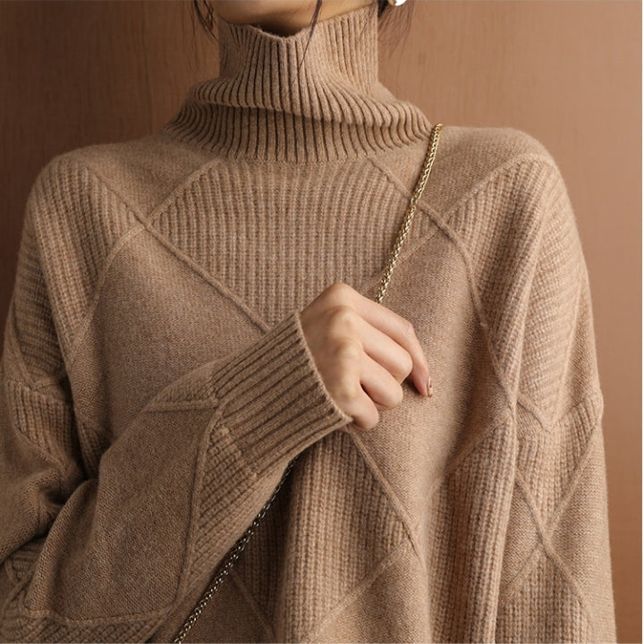 Woman wearing a brown textured turtleneck sweater featuring long sleeves and ribbed cuffs.