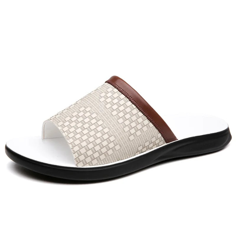 Side profile product shot of a white woven-texture leather slide sandal on a plain white background, showing the brown trim strap and black-and-white sole.