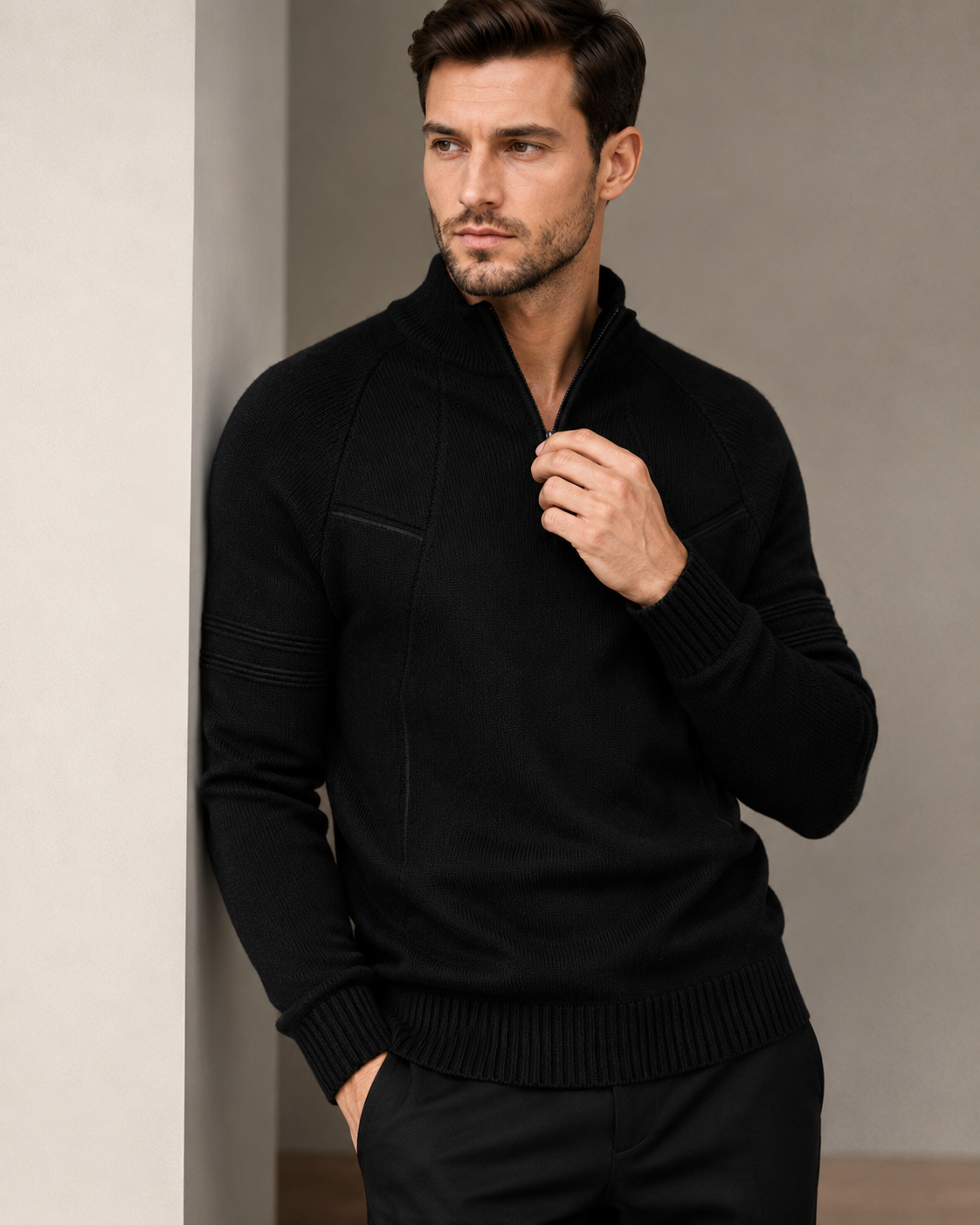 Fitted black knit quarter-zip sweater featuring raglan sleeves, raised chest seams, and ribbed trim details.