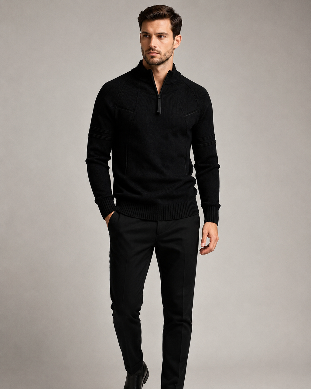 Black fitted knit quarter-zip sweater with raglan sleeves, raised chest seams, and ribbed cuffs on a standing model.